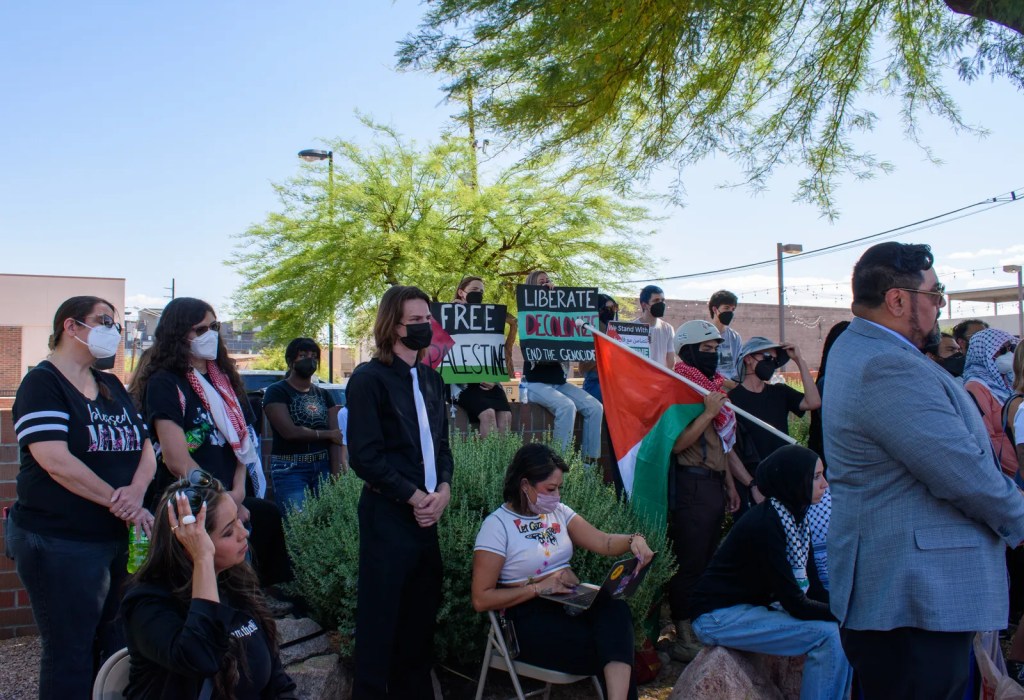 People listen to attorneys speak outside the Ocotillo Regional Court Center in Chandler, Arizona, with the abolitionist group Mass Liberation Arizona on May 14, 2024.