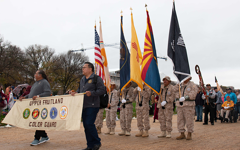 A military color guard from Upper Fruitland on the Navajo Nation marches as part of the dedication ceremony for the National Native American Veterans Memorial in Washington. 